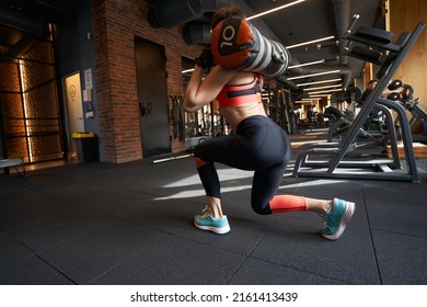 Fit Woman Doing Sandbag Workout At Gym