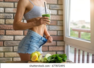 Fit Woman Drinking Vegetable Green Detox Smoothie.  Raw Food Diet