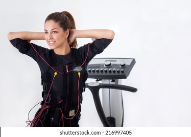 fit woman exercise on electro muscular machine