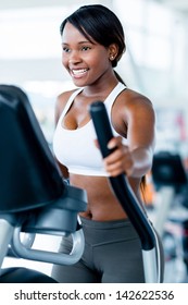 Fit Woman Exercising At The Gym On An X-trainer