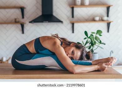 Fit Woman Exercising At Home, Seated Forward Fold