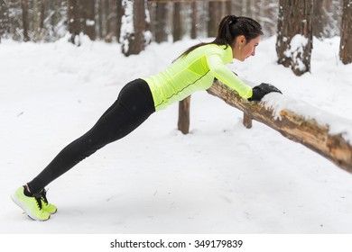 Fit Woman Exercising In Woods Doing Push Ups On A Log At Park. Outdoor Training Workout Winter Morning Side View