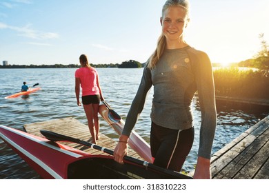 Fit woman with a kayak getting ready for practice - Powered by Shutterstock