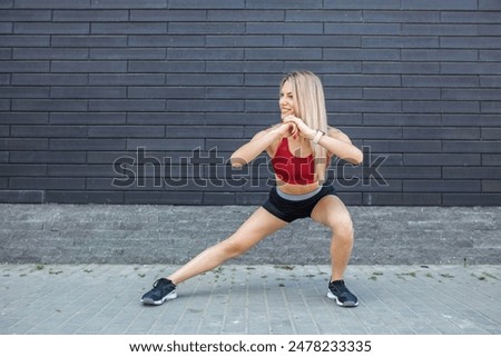 Similar – Image, Stock Photo Slim female doing side plank star pose during yoga session in park