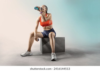 Fit woman relaxes and drinking water on seaside promenade after Workout training. - Powered by Shutterstock