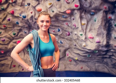 Fit Woman At The Rock Climbing Wall At The Gym