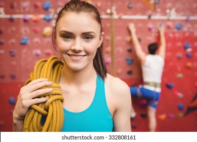 Fit woman at the rock climbing wall at the gym - Powered by Shutterstock