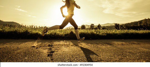 Fit Woman Running Fast, Training In Bright Sunshine