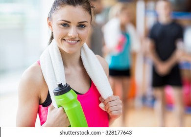 Fit woman smiling at camera at the gym - Powered by Shutterstock