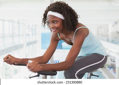 Fit Woman Working Out On The Exercise Bike At The Gym