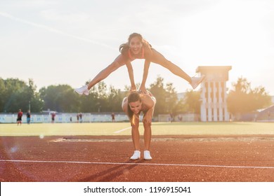 Fit Women At The Stadium Playing Leap Frog.