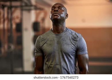 Fit Young African American Man Standing With His Eyes Closed And Sweating After A Gym Workout