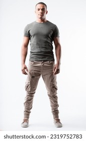 Fit young black man, V-shaped chest, lean waist in a relaxed yet strong pose. Very short hair, military-inspired outfit, low sneakers, slight smile. Full frontal portrait, isolated from background