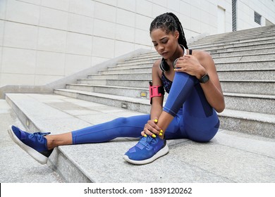 Fit young Black sportswoman suffering from pain in her ankle after morning jog - Powered by Shutterstock