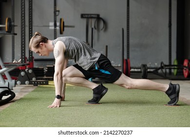 Fit Young Man Doing Exercise With Gliding Discs To Improve Stability.