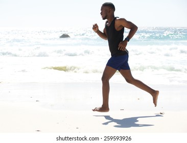 Fit young man running work out at the beach