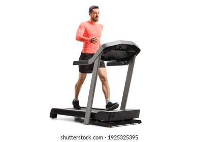 Fit Young Man In Sportswear Walking Fast On A Treadmill Isolated On White Background