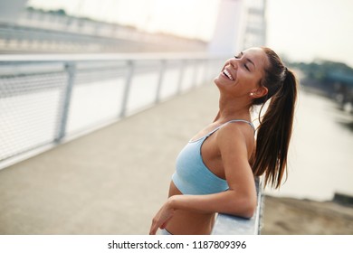 Fit young woman catching her breath during training - Shutterstock ID 1187809396