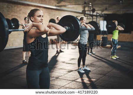 Similar – young adult trained woman concentrate at her excercise in gym