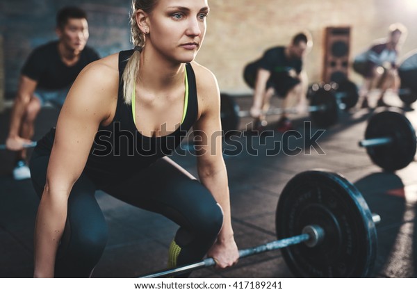 Fit Young Woman Lifting Barbells Looking Stock Photo 417189241 ...