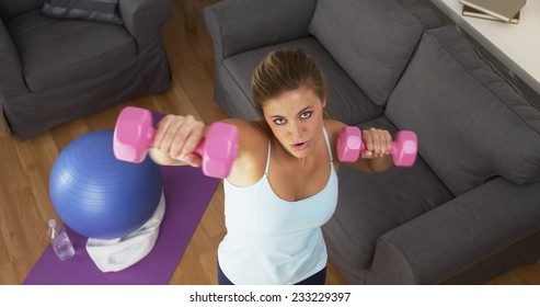 Fit Young Woman Lifting Weights At Home