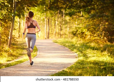 Fit Young Woman Running In Park