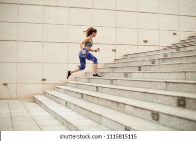 Fit Young Woman Running Up The Stairs