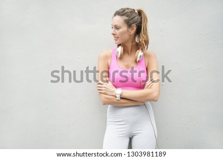 Similar – Young woman stretching arms before training outdoors