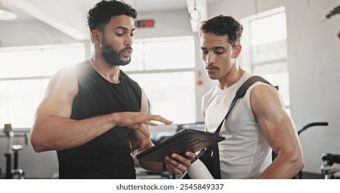 Fitness, advice and men in gym with tablet for online registration, planning or workout schedule. Athlete, personal trainer and digital app for exercise, progress results or membership at sports club - Powered by Shutterstock