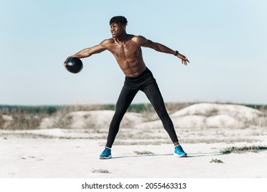 Fitness African American Man Doing Workout Twist Exercise With Medicine Ball Weight, Outdoors In Nature, Athlete Doing Langs And Torso Rotation For Abs Workout