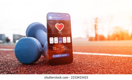 Fitness Application. Smartphone Screen With Sport Gym Or Fitness Health Mobile Application On Dumbbell Background. Online Fitness Program