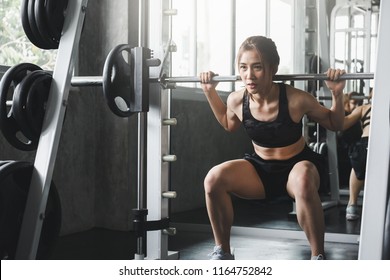 Fitness Asian Woman Doing Exercise And Lifting Barbell Weights In Sport Gym, Healthy Lifestyle Concept