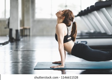 Fitness Asian Woman Doing Yoga Exercise And Relax With Sportswear In Sport Gym, Healthy Lifestyle Concept