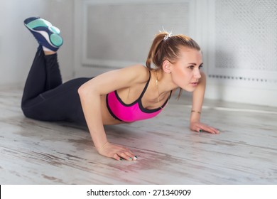 Fitness Athlete Sportive Woman Sport Model Girl Training Crossfit Doing Push Ups At Home.