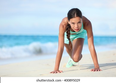 Fitness Athlete Working Out Body Core With Bodyweight Exercises. Strong Fit Woman Training Cardio And Exercising Abdominal Muscles With Mountain Climber Workout Exercise On Beach.