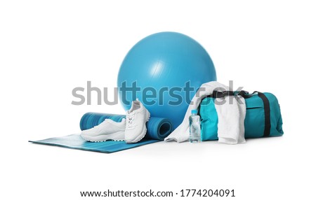 Fitness ball, gym bag and sport accessories isolated on white