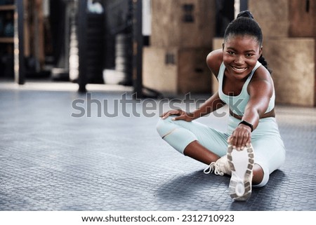 Fitness, black woman and stretching legs in gym for health or preparing for workout or flexibility and mobility. Train, wellness and African female athlete or warmup or cardio exercise and routine