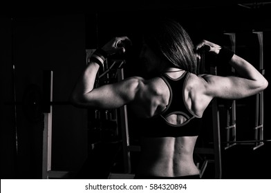 Fitness Bodybuilding Woman Instructor Show Her Muscles After Workout In The Gym. 