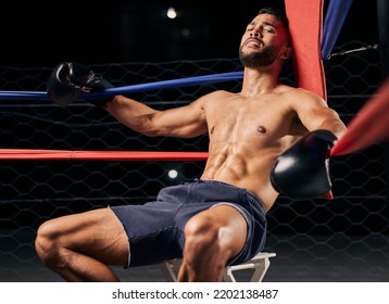 Fitness, Boxer And Man Tired In Ring Out Corner Exhausted From Sports Boxing Match At The Gym Or Arena. Active Male In Fight Club, Fatigue And Relaxing From Intense Fighting Sport Workout Or Exercise