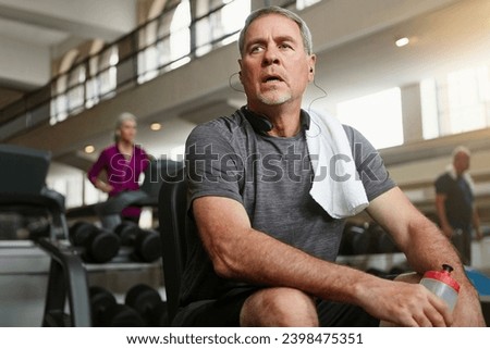 Fitness, break and tired senior man at a gym with water after training, exercise or challenge. Sports, fatigue and elderly male person with liquid for hydration, recovery or resting from workout