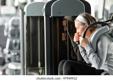 Fitness Center Senior Woman Exercise Abs Muscle On Gym Machine