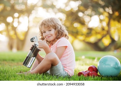 Fitness Child. Portrait Of Sporty Little Boy With Sport Bottle Water In Park. Gym Workout. Child Sportsman, Childhood Activity. Kids Sport And Fitness.