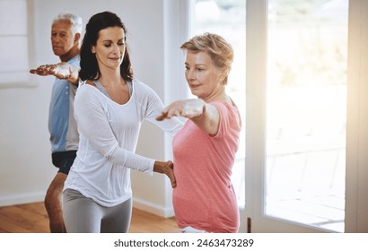 Fitness class, mature woman and yoga instructor helping with warrior pose for exercise guidance and wellness. Health, people and coach for workout lesson, instruction and body posture support - Powered by Shutterstock