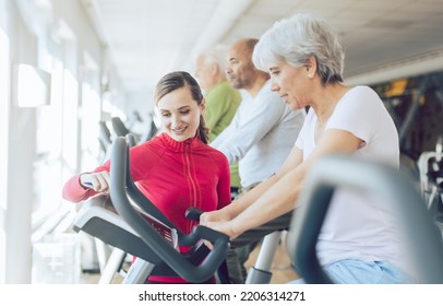 Fitness Coach In Gym Helping Senior People