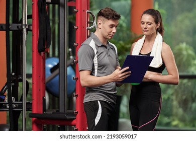 Fitness coach talking to fit female client when explaining new training plan - Shutterstock ID 2193059017