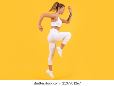 Fitness Coach Woman Jumping On Yellow Background