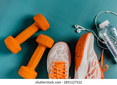 Fitness concept, essential running item, top view of running shoes, water, smartphone and headphones - Powered by Shutterstock