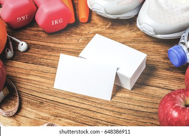 Fitness Concept With Exercise Equipment On Wooden Background.business Card