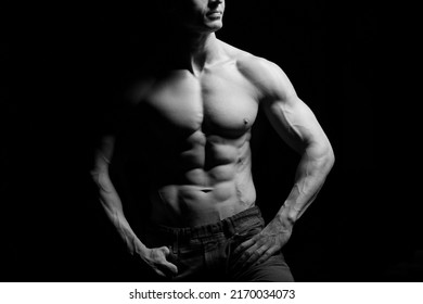 Fitness Concept. Muscular And Fit Torso Of Young Man Having Perfect Abs, Bicep And Chest. Male Hunk With Athletic Body On Black Background