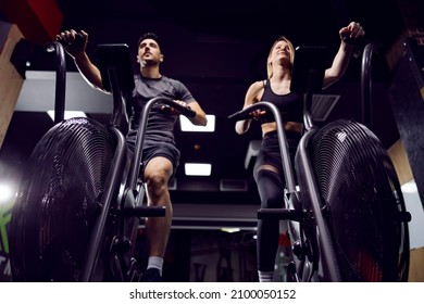 Fitness couple practicing on exercise bike in a gym. - Powered by Shutterstock